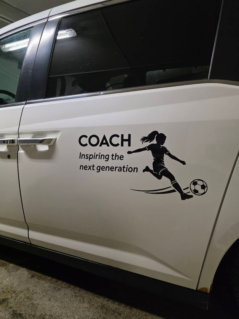 Black Coach Inspiring the next generation soccer decal installed on a white client vehicle door