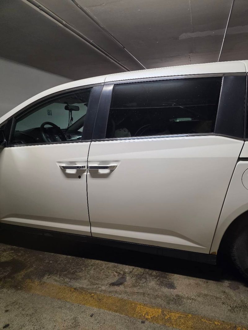 White client vehicle door before the custom coach decal was installed