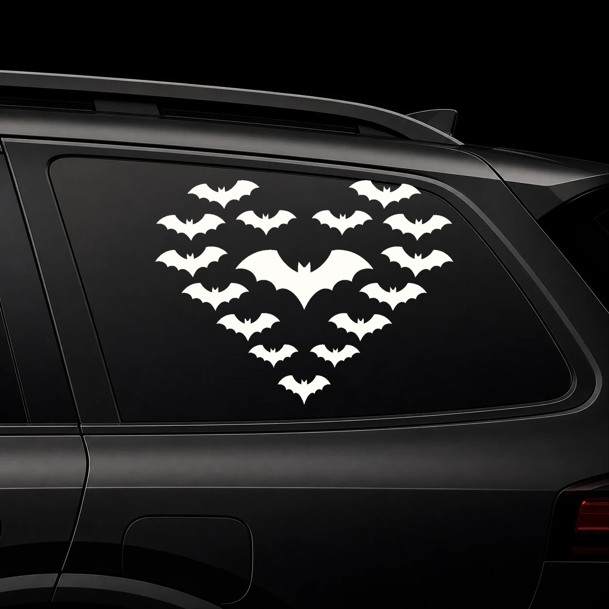 A heart shape made from bats on a dark vehicle window