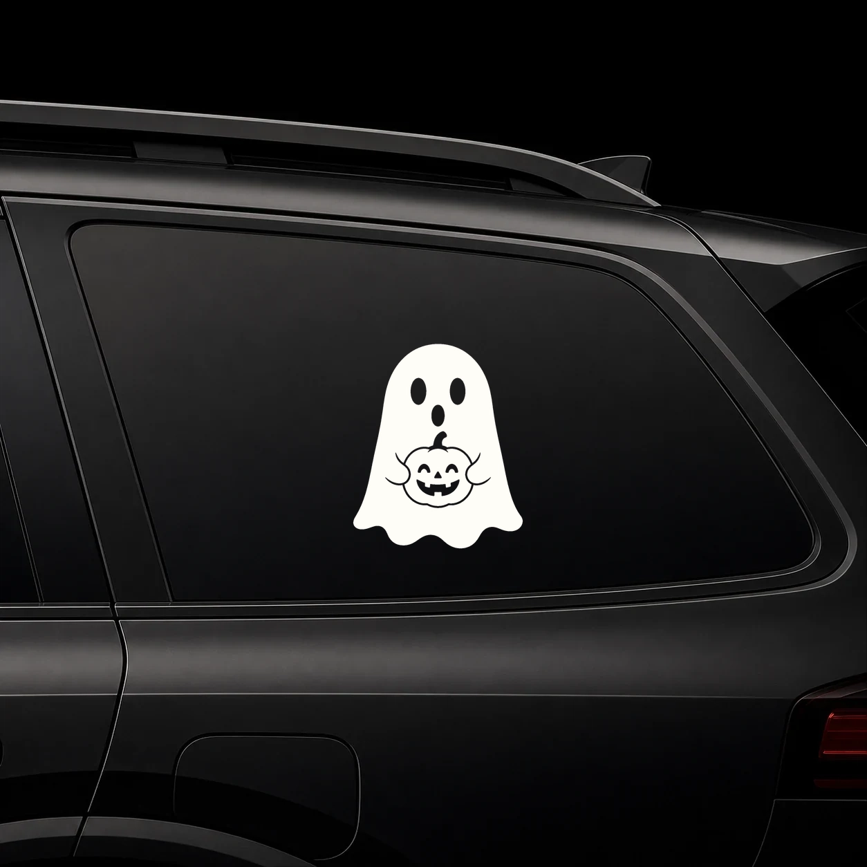 Cute ghost holding a pumpkin decal on a dark vehicle window