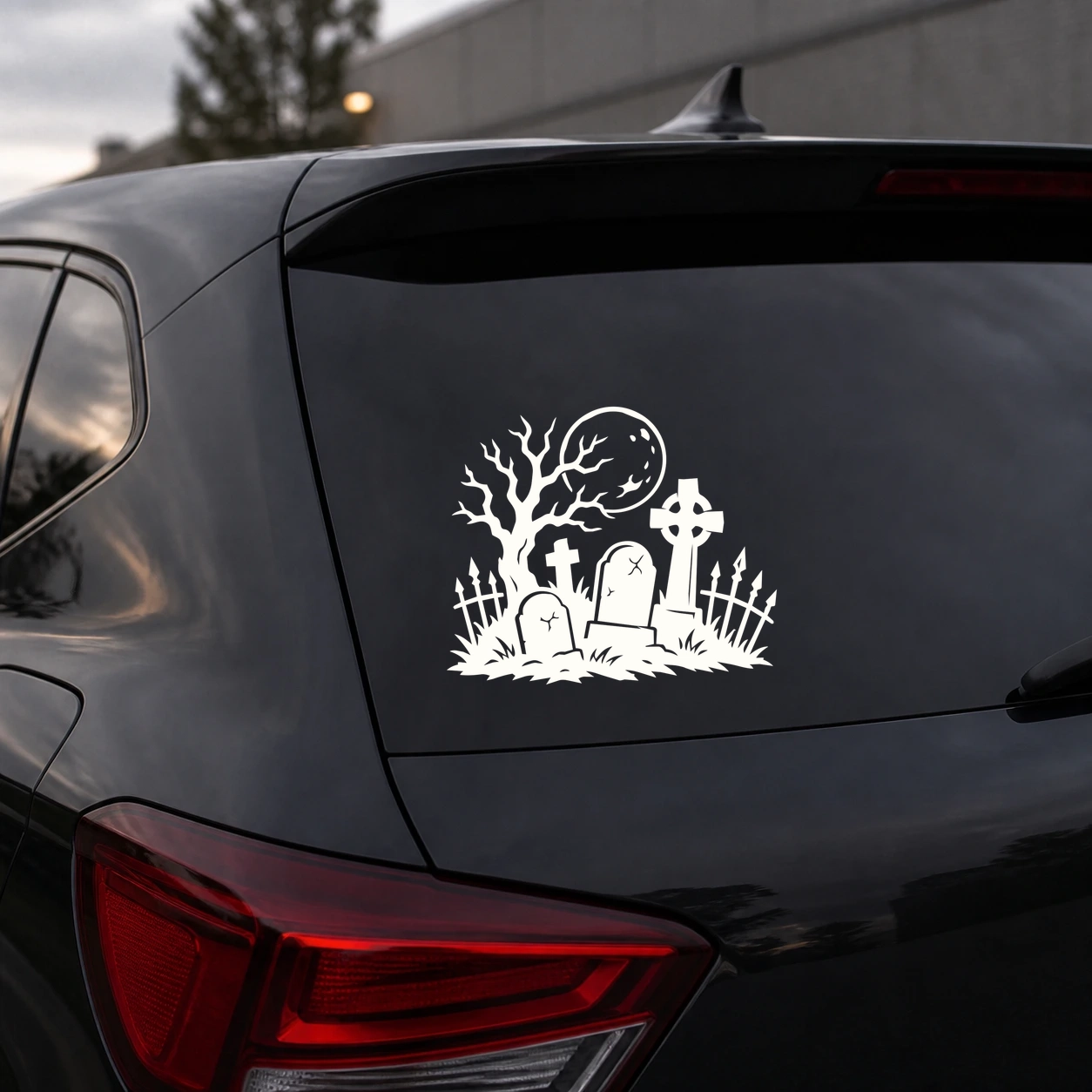 Warm ivory graveyard moon decal on a dark vehicle rear window