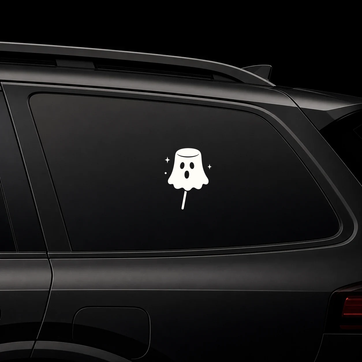 Marshmallow ghost decal on a dark vehicle window