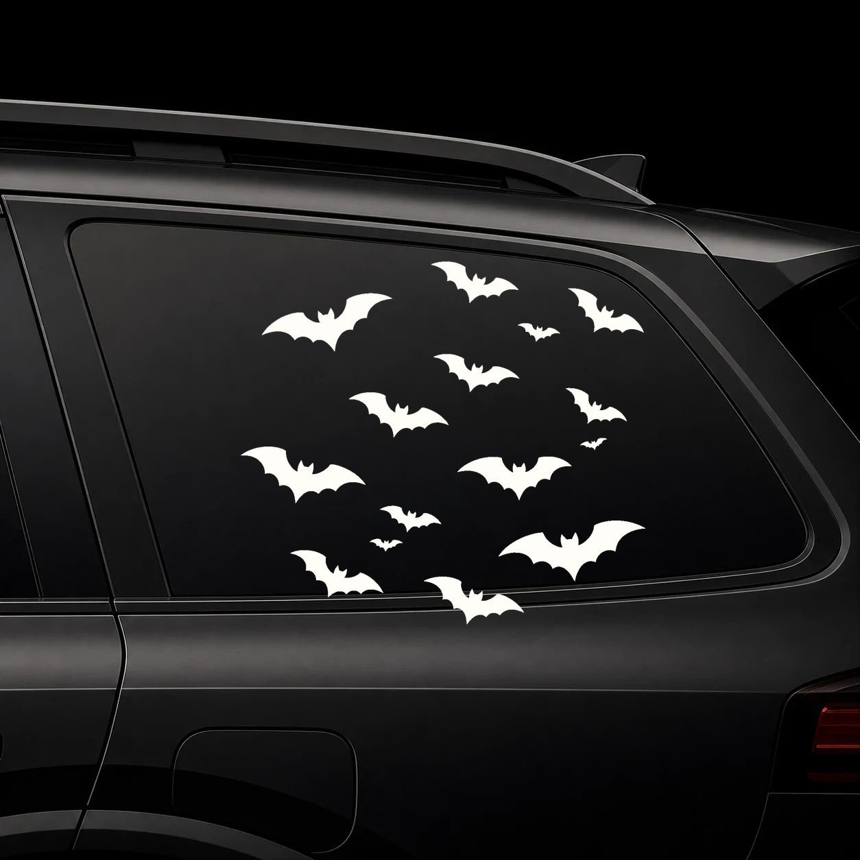 Warm ivory mini bat swarm decal set on a dark vehicle window