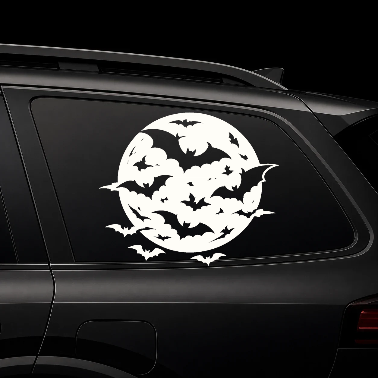 A full moon filled with bats on a dark vehicle window
