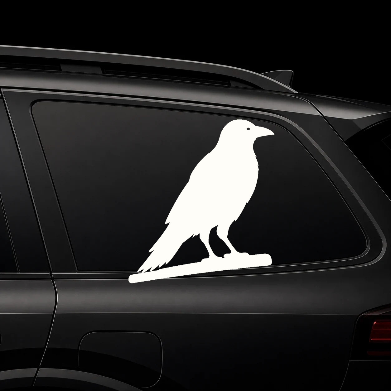 Warm ivory raven decal positioned above a dark vehicle rear-window wiper