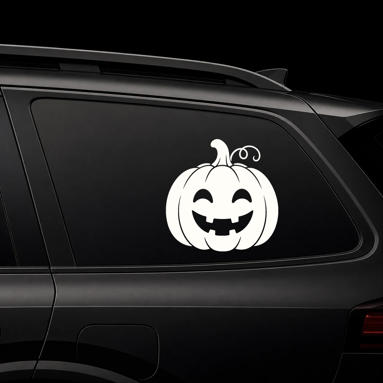 Cute pumpkin vinyl decal on a dark vehicle rear window
