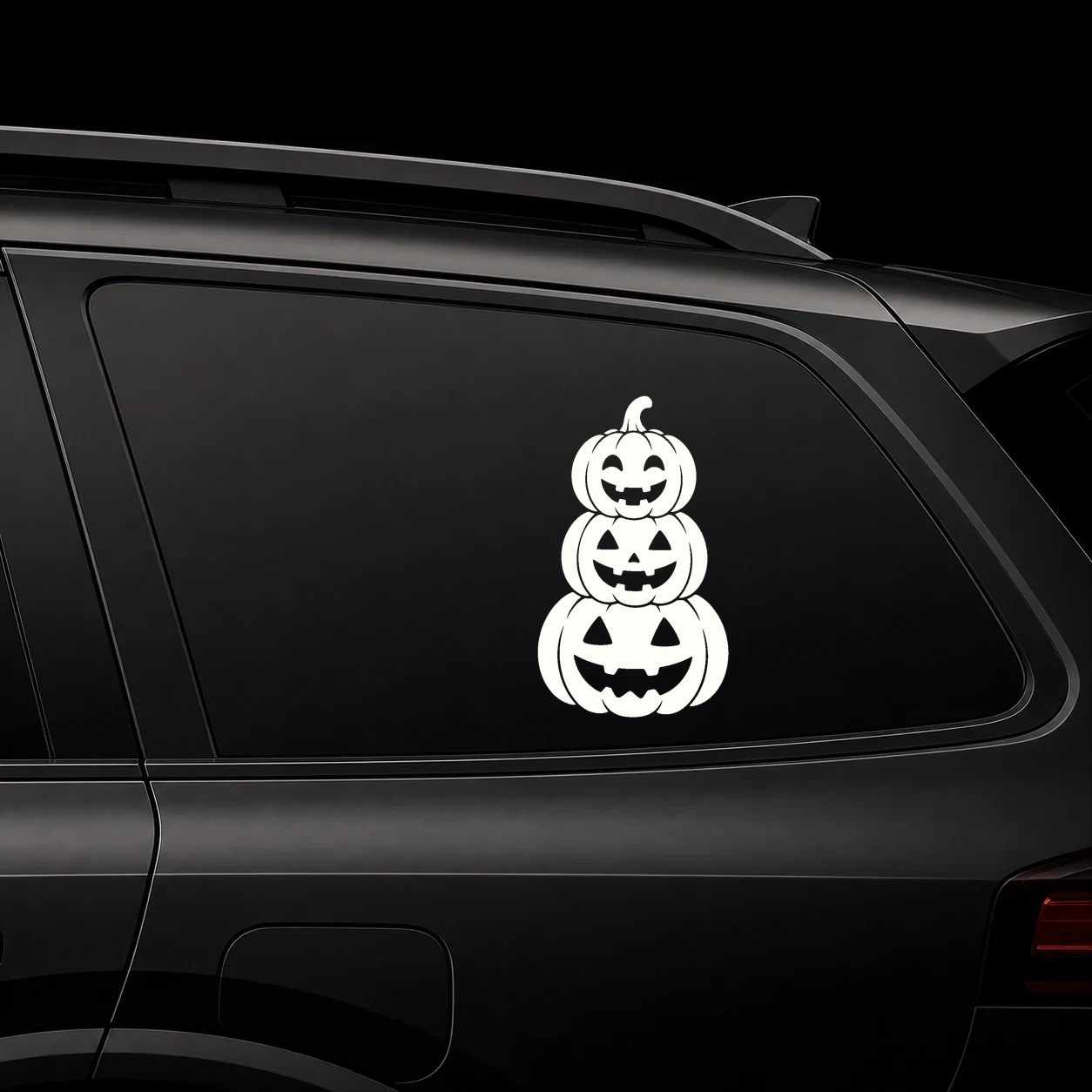 Pumpkin scene vinyl decal on a dark vehicle rear window