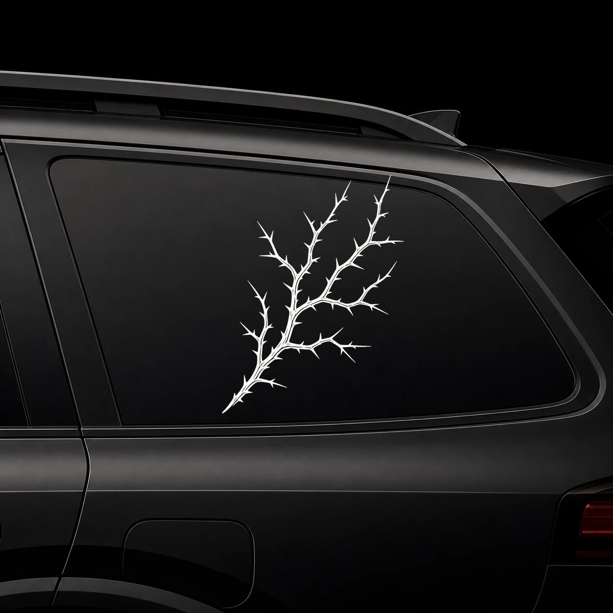 Detailed thorn branch decal on a dark vehicle window