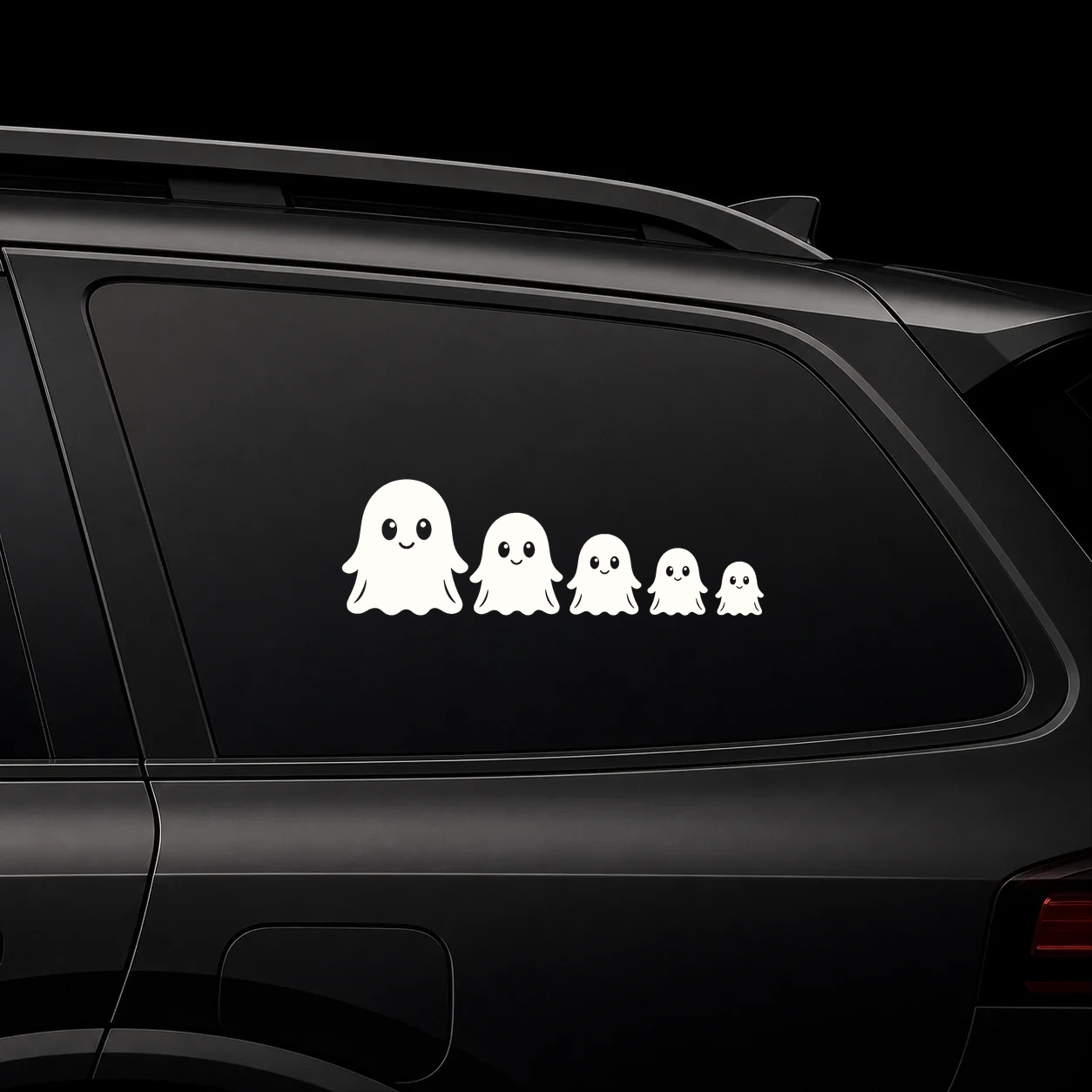 A row of tiny friendly ghost decals on a dark vehicle window