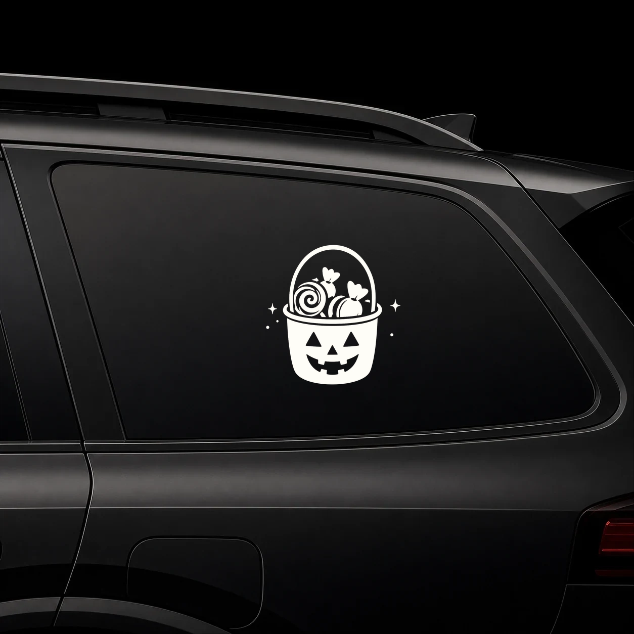 Trick-or-treat bucket decal on a dark vehicle window
