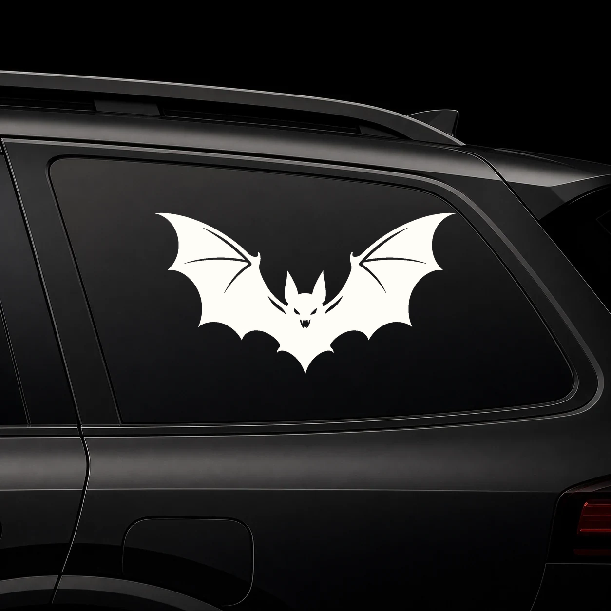A bold vampire bat silhouette on a dark vehicle window