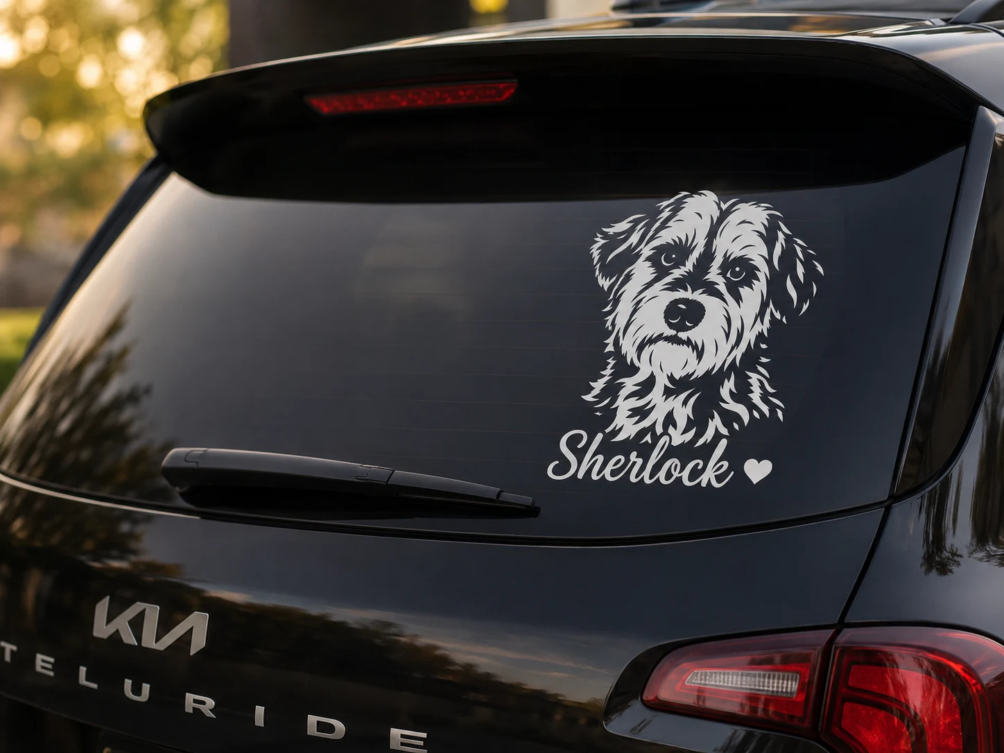 Sherlock’s finished white pet portrait decal, with his name, on a vehicle rear window