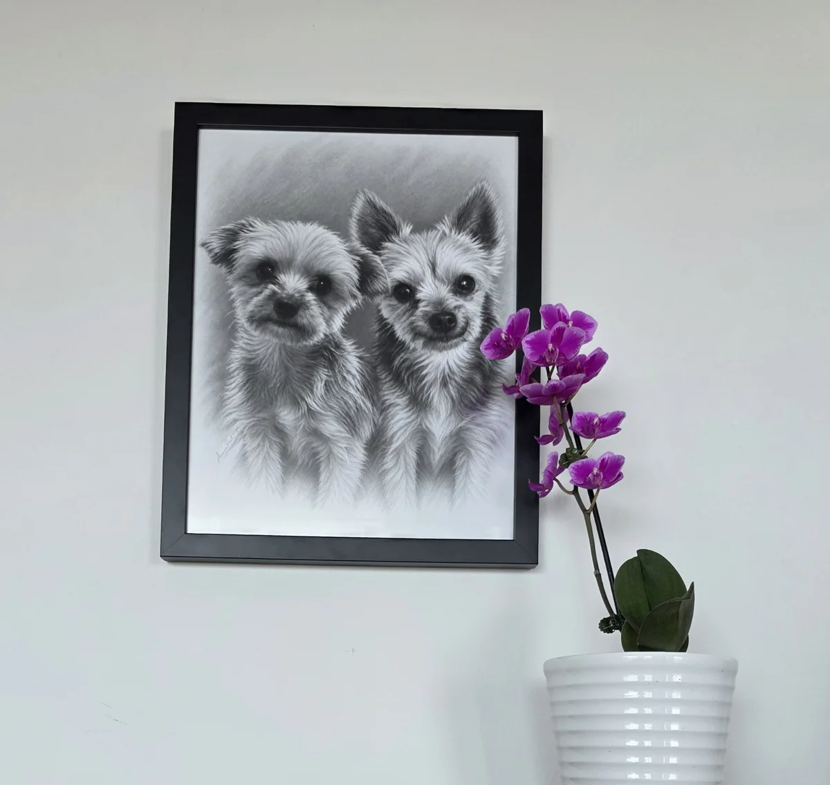Cash and Louis custom portrait displayed in a black frame