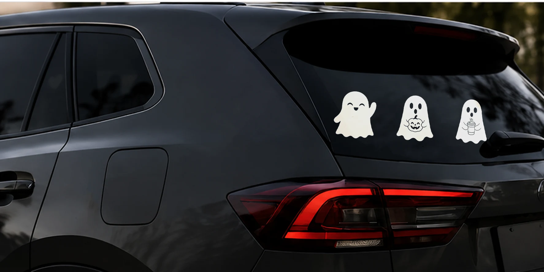 Three friendly ghost decals installed together on a rear vehicle window