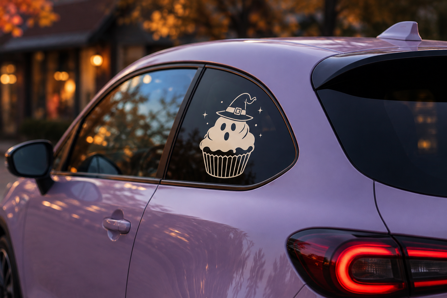 Ghost cupcake decal on a lavender car window at dusk