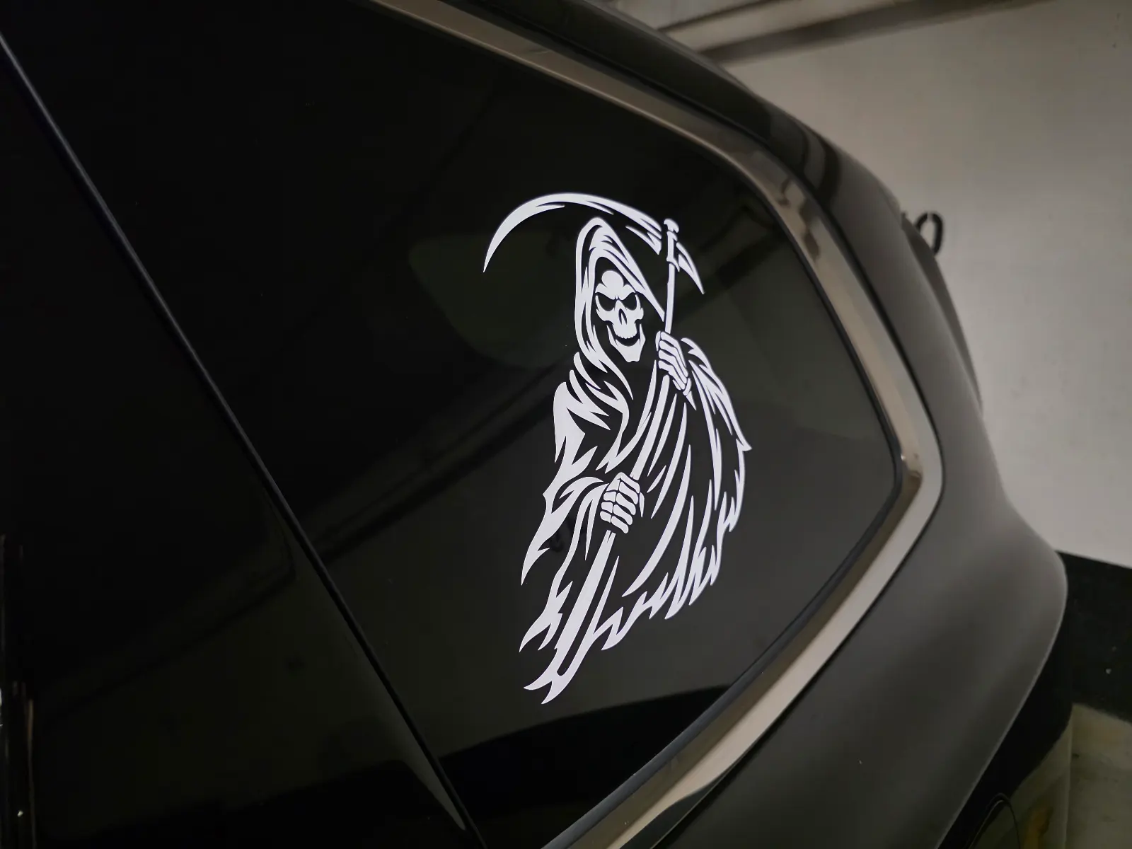 White Grim Reaper decal installed on a client's dark rear vehicle window