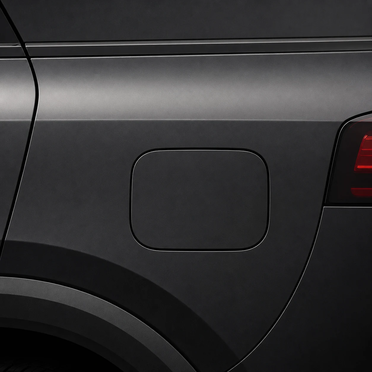 Warm ivory pair of ghost decals peeking from opposing edges of a dark vehicle fuel door
